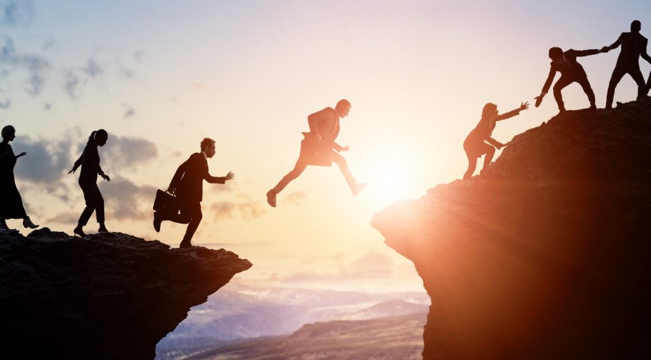 Challenge of business concept. Group of businesspeople climbing a mountain. Teamwork. Success.